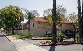 Rialto multi-family for rent - A building with a sign that says "Tulipa Palm" in front of it.