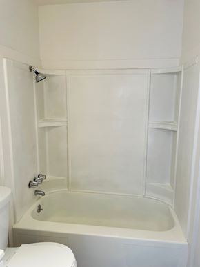 Vallejo apartment for rent - A white bathroom with a toilet, tub, and shower.