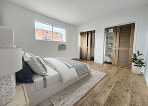 Santa Monica apartment for rent - A bedroom with a large bed and a wooden floor.