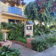 Santa Monica apartment for rent - A small sign is in front of a yellow building.