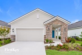 Palm Coast house for rent - a white house with a garage door and a driveway