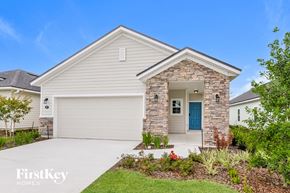 Palm Coast house for rent - a white house with a blue door and a driveway