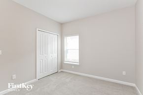 Palm Coast house for rent - a bedroom with a white door and a window and a carpeted floor