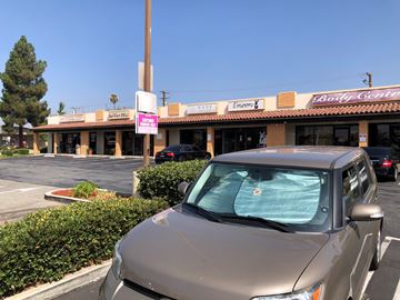 Upland apartment for rent - a car parked in a parking lot in front of a restaurant