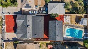 Canoga Park apartment for rent - a birds eye view of the roof of a house with a pool