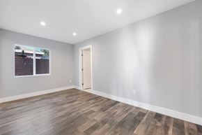 Canoga Park apartment for rent - a living room with white walls and wood floors