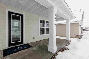 Woodbury house for rent - a front entrance of a home with snow on the sidewalk