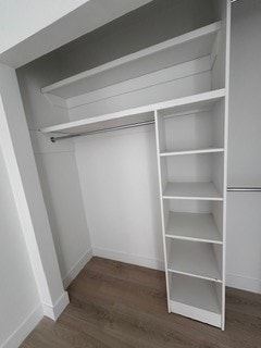 Calgary apartment for rent - A white shelving unit in a room with wooden flooring.