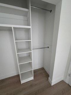 Calgary apartment for rent - A white shelving unit with four shelves is in a corner of a room.
