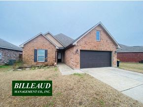 Lafayette house for rent - A brick house with a garage door and a sign that says Billeaud Management Co., Inc.