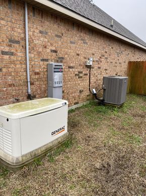 Lafayette house for rent - A white generator sits outside a brick building.