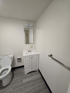 Coatesville apartment for rent - a bathroom with a toilet and a sink and a mirror