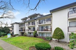 Vancouver apartment for rent - Apartment complex with a green lawn in front.