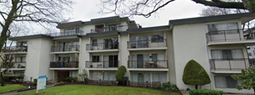 Vancouver apartment for rent - Apartment building with balconies and greenery in front.