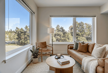 Seattle apartment for rent - A living room with a couch, chair, and a table with a book on it.