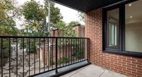 Westmount apartment for rent - a balcony with a black railing and a brick building