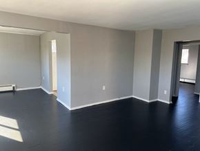Cincinnati apartment for rent - A room with a dark floor and white walls.