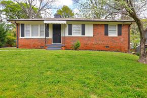 Atlanta house for rent - A red brick house with a black front door and white trim.