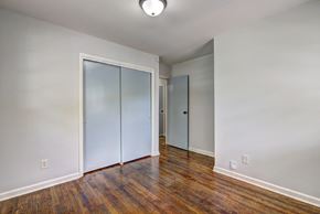 Atlanta house for rent - A room with a wooden floor and white walls with a sliding door.