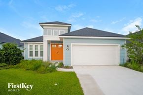 Palm Coast house for rent - a house with a orange door and a driveway