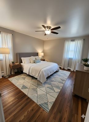 Cincinnati apartment for rent - A bedroom with a bed, nightstand, and a ceiling fan.