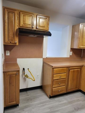 Coatesville apartment for rent - A kitchen with wooden cabinets and a white refrigerator.