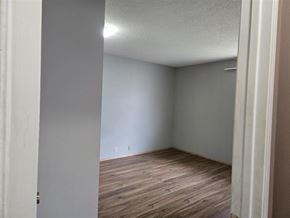 Calgary house for rent - A room with wooden flooring and white walls.