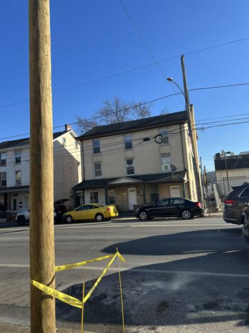 Coatesville apartment for rent - A yellow caution tape is strung between two wooden posts.