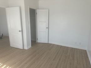 Los Angeles apartment for rent - A room with two white doors and wooden flooring.