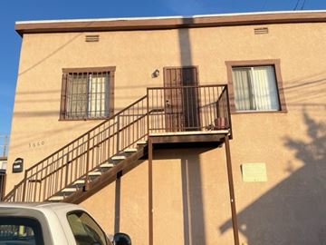 Los Angeles apartment for rent - A tan building with a black metal staircase.