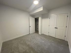 Edmonton apartment for rent - a bedroom with a carpeted floor and white doors