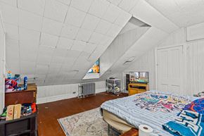 Chester apartment for rent - A room with a bed, a dresser, and a window with a view of a playground.