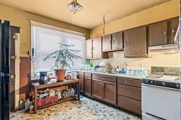 Chester apartment for rent - A kitchen with brown cabinets and a white stove.