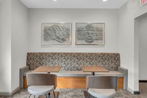 Millbury apartment for rent - a dining area with two tables and chairs and two paintings on the wall