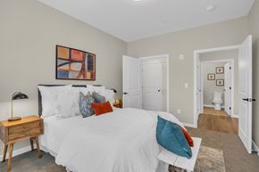 Millbury apartment for rent - a bedroom with a large bed and a bathroom with a toilet