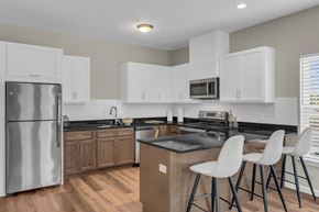 Millbury apartment for rent - a kitchen with white cabinets and a stainless steel refrigerator