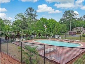 Atlanta house for rent - a swimming pool with a chain link fence around it