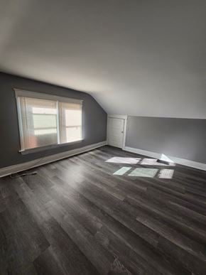 Cincinatti apartment for rent - A room with wooden flooring and a window with blinds.