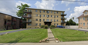 Cincinnati apartment for rent - A large apartment building with a green lawn in front.