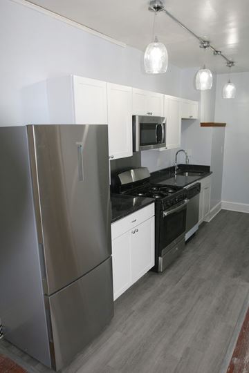 Philadelphia apartment for rent - a kitchen with stainless steel appliances and white cabinets