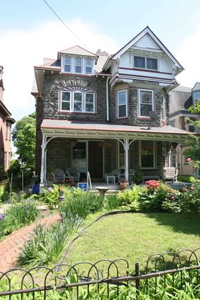 Philadelphia apartment for rent - a house with a lawn and a garden in front of it