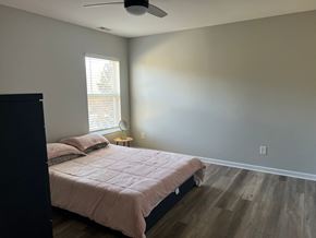 Waxhaw house for rent - a bedroom with a bed and a ceiling fan