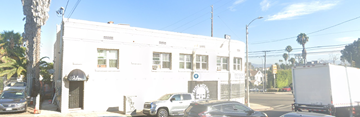 Los Angeles apartment for rent - a white building with cars parked in front of it