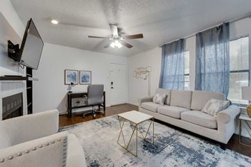 Irving house for rent - a living room with a couch and a chair and a ceiling fan