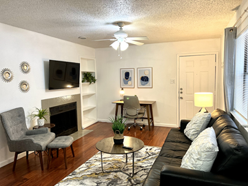 Irving house for rent - a living room with a couch and a table and a fireplace