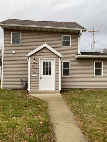 Rochester house for rent - A house with a grey siding and a white door.