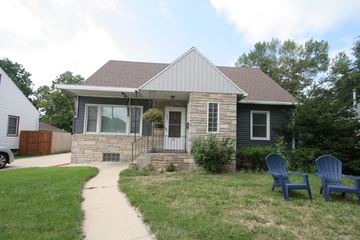 Rochester apartment for rent - A house with a grey roof and a stone pillar in front of it.