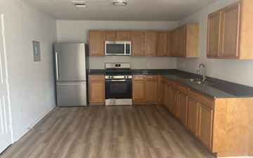 Fairfield apartment for rent - A kitchen with wooden cabinets and a black countertop.