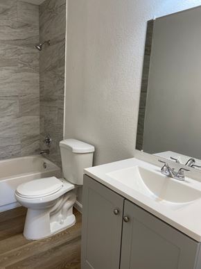 Fairfield apartment for rent - A white toilet sits next to a white sink in a bathroom.