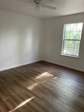 Fairfield apartment for rent - A room with a ceiling fan and a window with a view of trees.